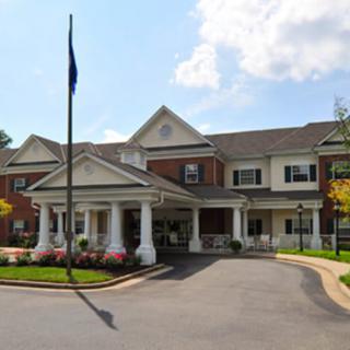 A well-maintained residential building with a covered entrance and landscaped surroundings.