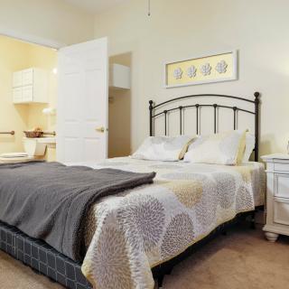 A cozy bedroom with neutral tones and simple decor.