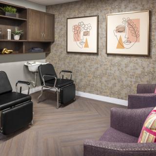 A modern office seating area with stylish chairs and artwork adorning the walls.