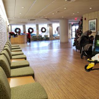 A spacious lobby featuring festive holiday decorations and comfortable seating.