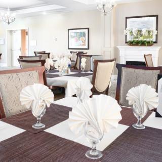 An elegantly set dining room with neatly folded napkins and stylish decor.