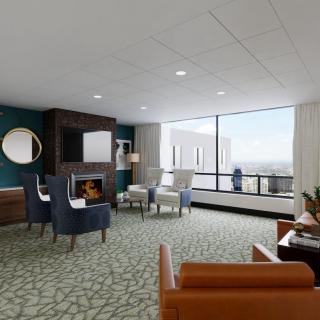 A modern living room with comfortable seating and a large window offering a scenic view.