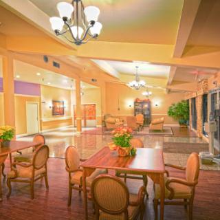 A spacious and inviting lobby with elegant furnishings and warm lighting, perfect for relaxation or social gatherings.