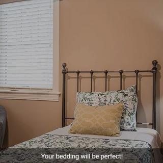 A neatly arranged bed in a cozy bedroom with decorative pillows.