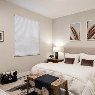 A modern, cozy bedroom with neutral tones and stylish decor.
