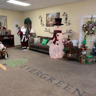A cozy holiday-themed setting featuring Santa Claus and a joyful snowman, adorned with festive decorations.
