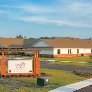 A serene residential area with modern housing and a welcoming entrance sign.