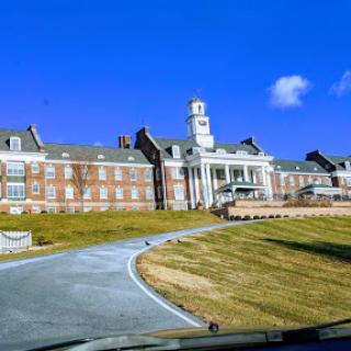 A scenic view of a prominent building against a clear blue sky.