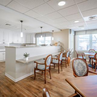 A modern dining area with elegant wooden furniture and stylish lighting.