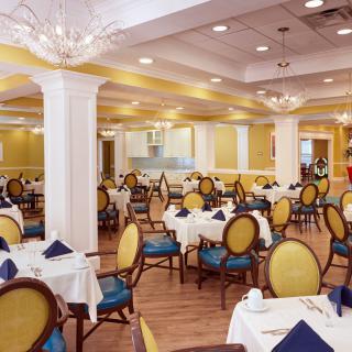 An elegant dining room with neatly set tables and classic decor.