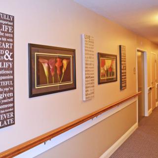A hallway adorned with framed artwork and decorative elements.