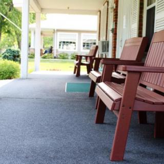 A serene porch with wooden chairs, perfect for relaxation.