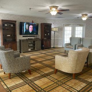 A spacious living room with comfortable seating and a large television.