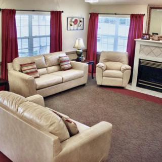 A cozy living room with comfortable seating and a fireplace.