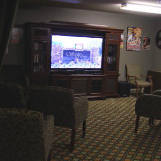 A cozy living room setting featuring a television and comfortable seating.