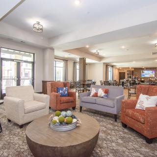A cozy and modern living room with a comfortable seating area and coffee table.