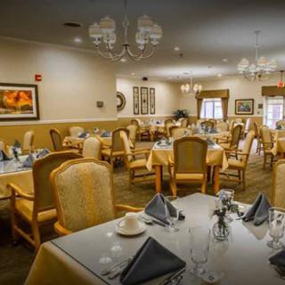 An elegant dining room featuring neatly arranged tables and chairs, ready for guests.