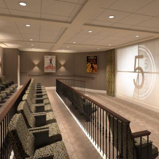 A cozy home theater with tiered seating and a large projection screen.