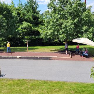 People relaxing and enjoying a sunny day in the park.