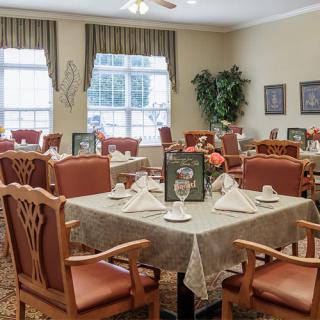 A well-arranged dining room with elegant table settings and comfortable seating.