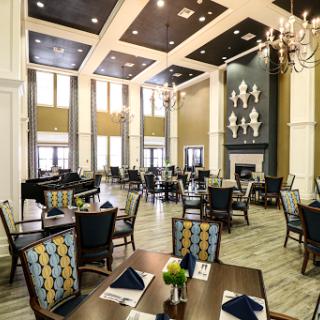 A beautifully designed restaurant featuring an elegant dining area with high ceilings and modern decor.