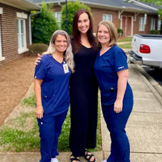 A group of healthcare workers posing together outdoors, showcasing their camaraderie and dedication.