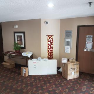 A view of a lobby area featuring furniture and unpacked boxes.