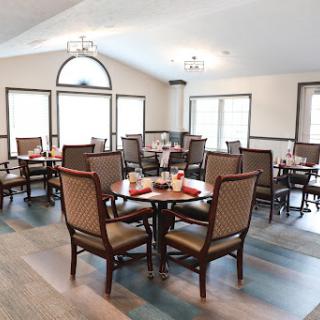 A beautifully arranged dining area featuring elegant tables and chairs, perfect for a cozy meal setting.