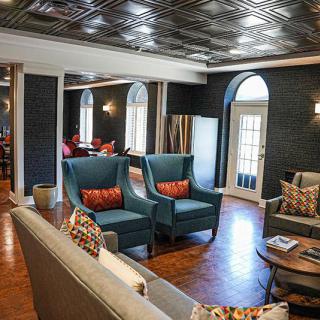 A stylishly decorated living room with modern furniture and wood flooring.