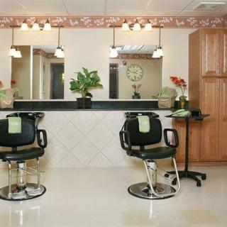 An empty hair salon with chairs and mirrors, featuring a clean and inviting interior design.