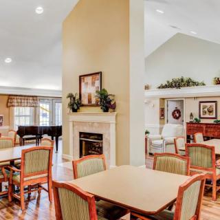 A cozy and elegantly furnished communal living and dining area with a fireplace.