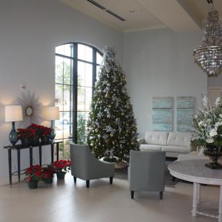 A beautifully decorated living room with a Christmas tree and festive holiday decorations.