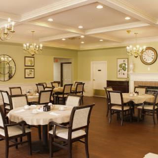 A beautifully arranged dining area featuring elegant tables and chairs, perfect for gatherings.