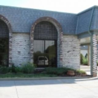 A commercial building with a stone facade and arched windows.