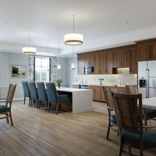 A spacious modern kitchen and dining area featuring wooden cabinets, an island countertop, and elegant pendant lighting.