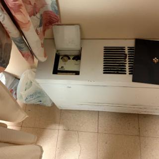 A view of a room featuring an air conditioning unit and curtains.