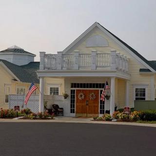 A residential building with flags at the entrance.