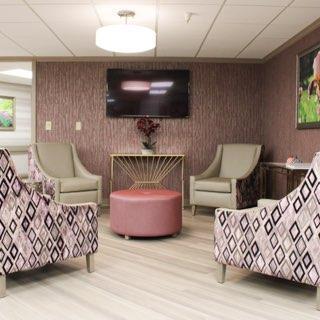 A modern lounge area featuring comfortable seating, a television, and decorative elements for a welcoming atmosphere.