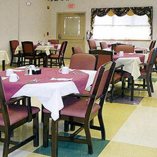 An empty dining area with tables and chairs arranged neatly.
