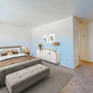 A modern and cozy bedroom featuring a stylish bed, elegant decor, and a serene color palette.