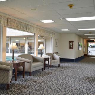 A spacious and well-lit lobby area with comfortable seating and large windows.