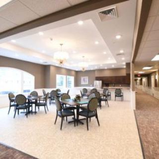 A modern and spacious dining area with multiple tables and chairs.