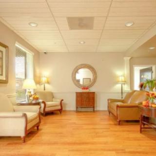A cozy waiting room with comfortable seating and warm lighting.