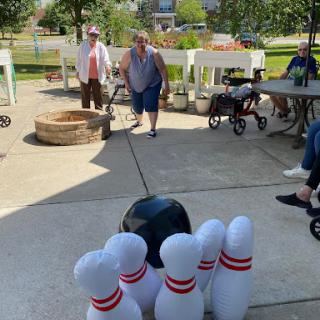 Enjoying a fun day of bowling in the sun at a community gathering.