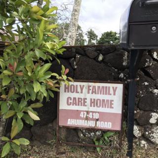 Sign for Holy Family Care Home with address details.