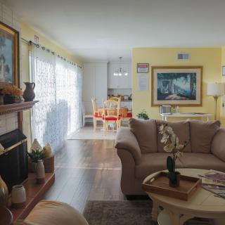 A cozy living room with a fireplace and an open dining area.