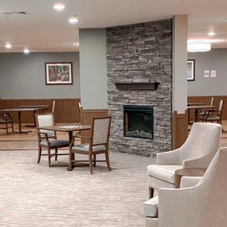 A cozy lobby with modern decor featuring a stone fireplace and comfortable seating.