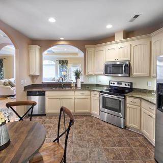 A modern kitchen with stainless steel appliances and a cozy dining area.