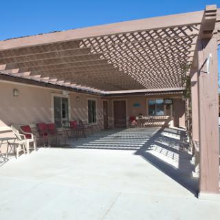 A sunny outdoor patio with a pergola, perfect for relaxation.