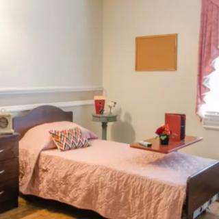 A cozy bedroom with a single bed and simple dcor.